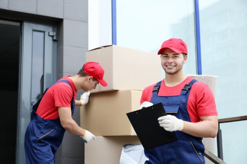 Professional movers handling furniture in Ham
